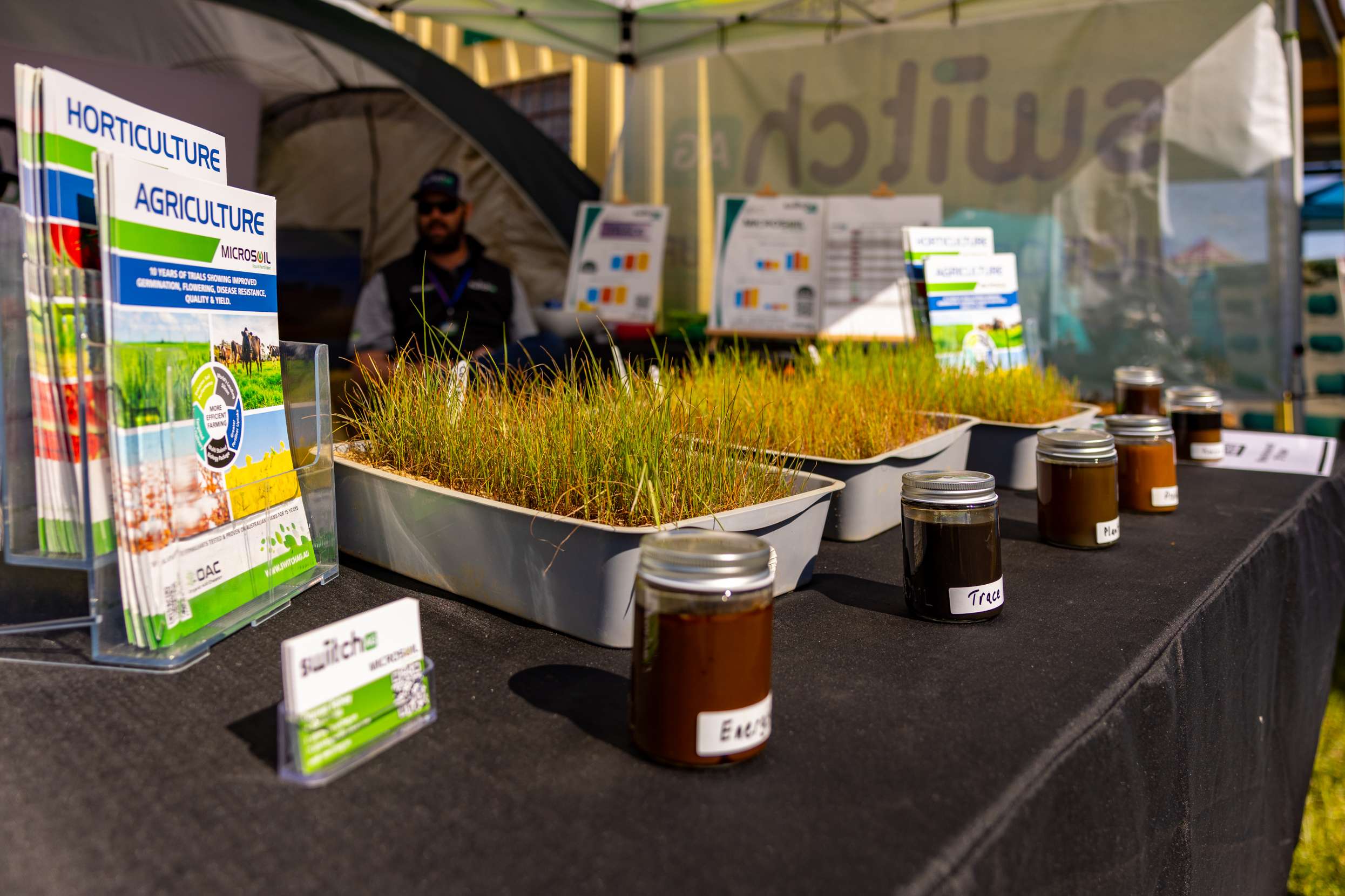 Switch Ag trade stand with horticulture and agriculture brochures, a seedling tray and liquid fertiliser samples